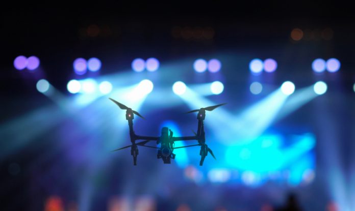 Closeup,Silhouette,Of,Drone,Flying,For,Taking,Video,Of,Concert