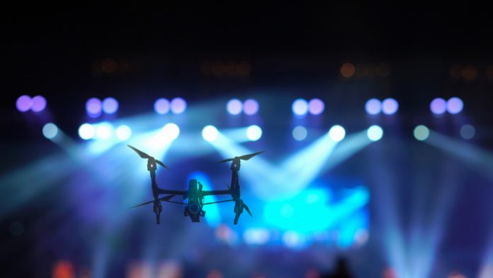 Closeup,Silhouette,Of,Drone,Flying,For,Taking,Video,Of,Concert